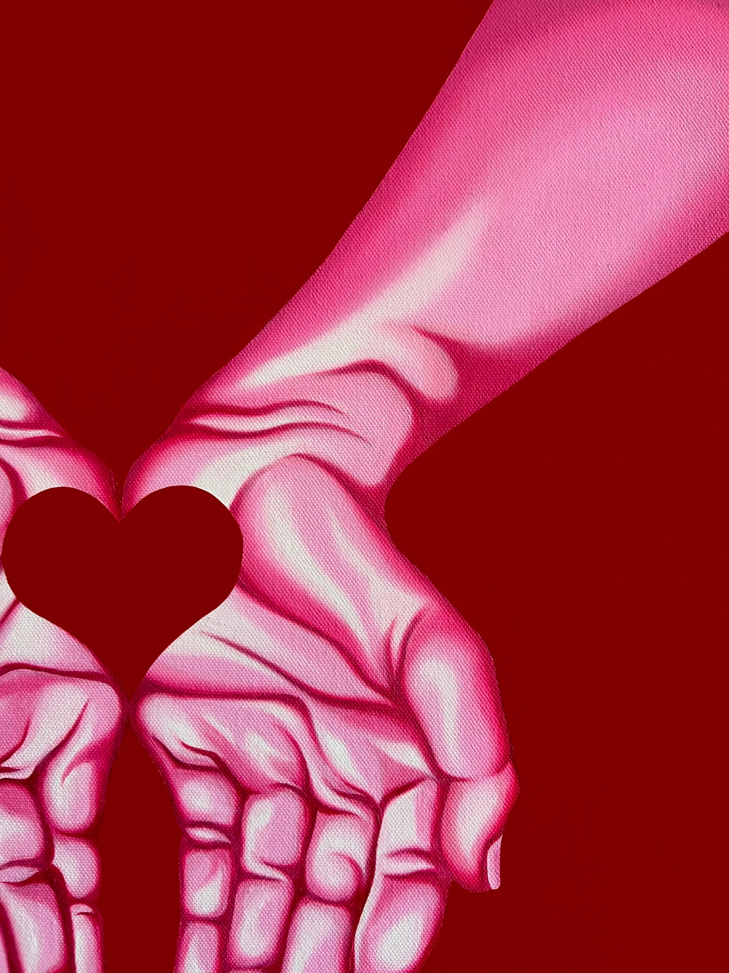 A stylized illustration of two pink-toned hands reaching toward each other against a solid dark red background, with a heart shape formed in the center.