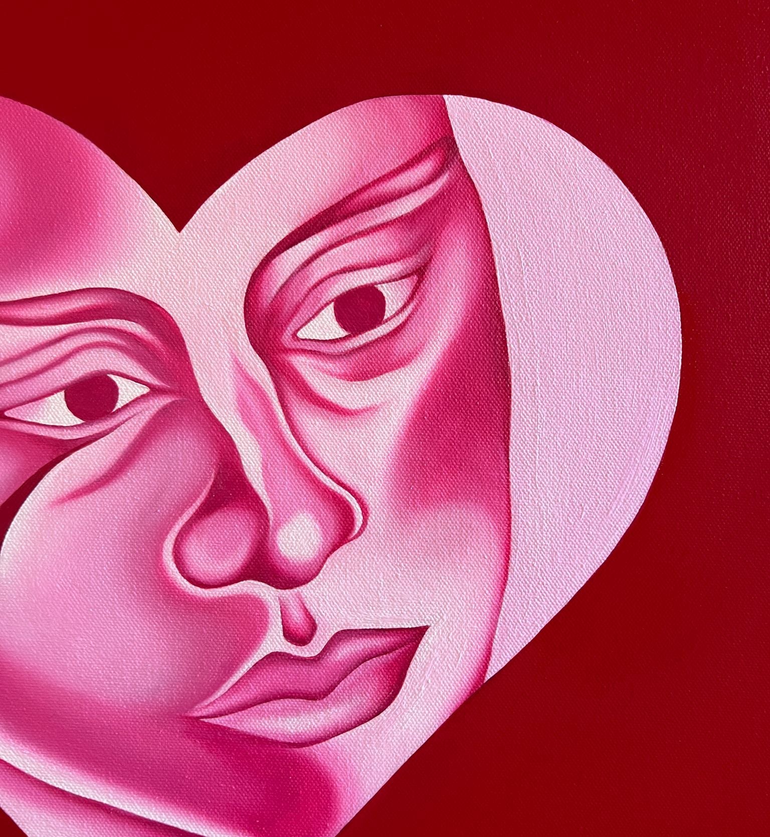 Artistic depiction of two faces within a heart shape on a red background