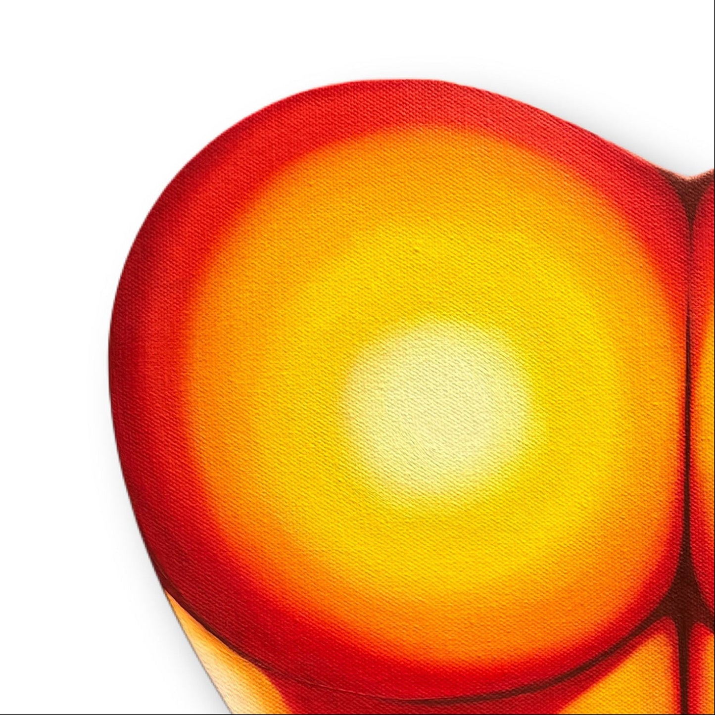 Close up of a heart-shaped painting of a peachy posterior with a gradient of red to yellow on a white background