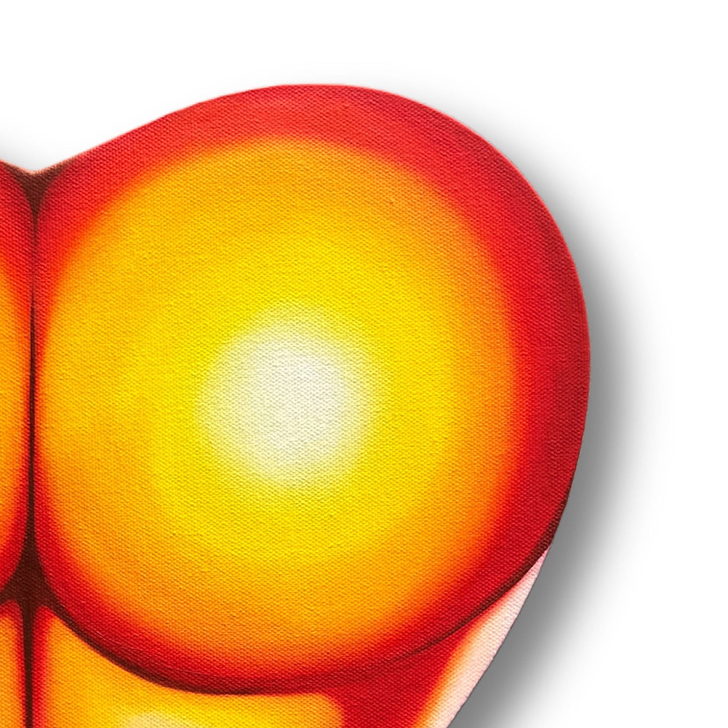 Close up of a heart-shaped painting of a peachy posterior with a gradient of red to yellow on a white background