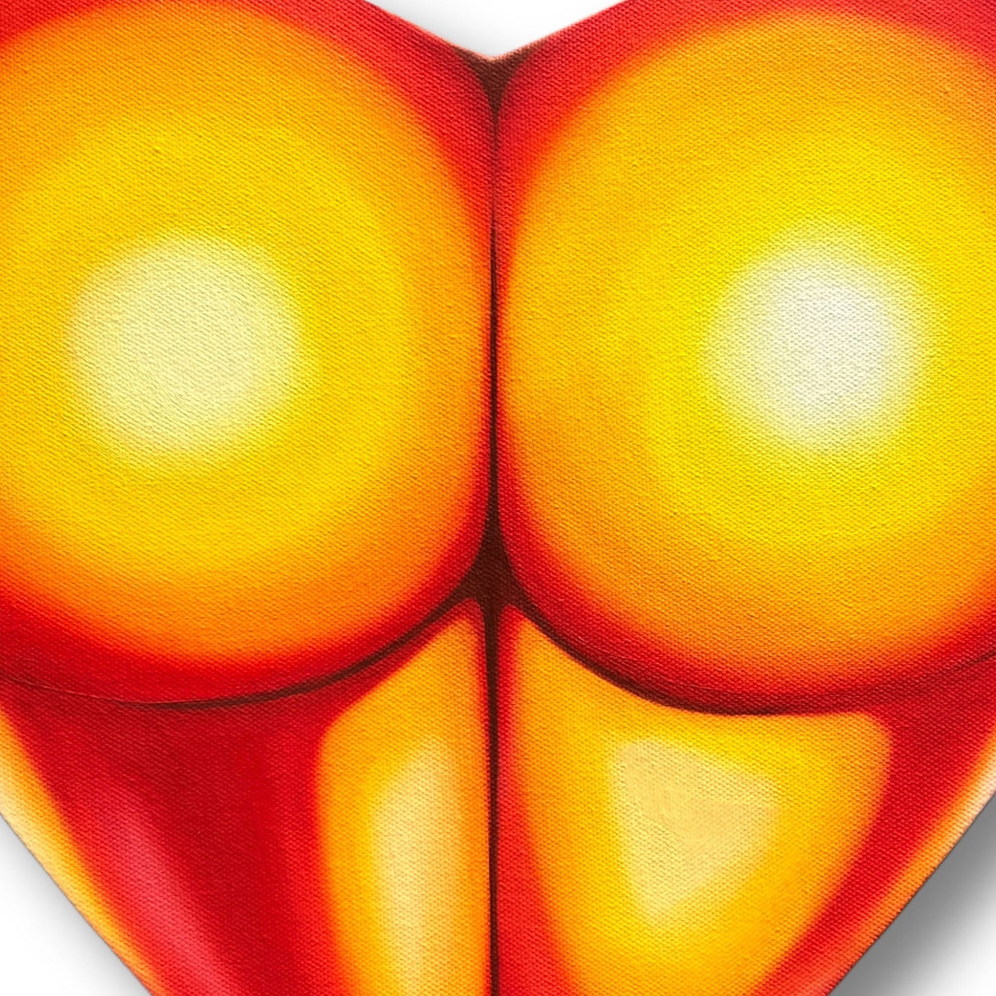 Close up of a heart-shaped painting of a peachy posterior with a gradient of red to yellow on a white background